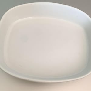 May include: White ceramic baking dish with a rounded rectangular shape.