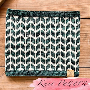 May include: A green and white knit cowl with a geometric pattern. The cowl has a label that says "Knit Love".