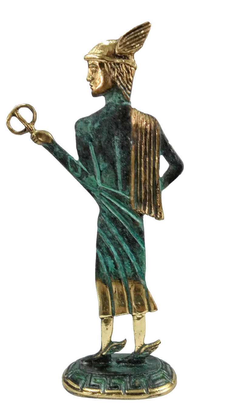May include: A bronze statue of a Greek god, standing on a base with a Greek key design. The statue is green and gold, and the god is holding a key in his right hand.