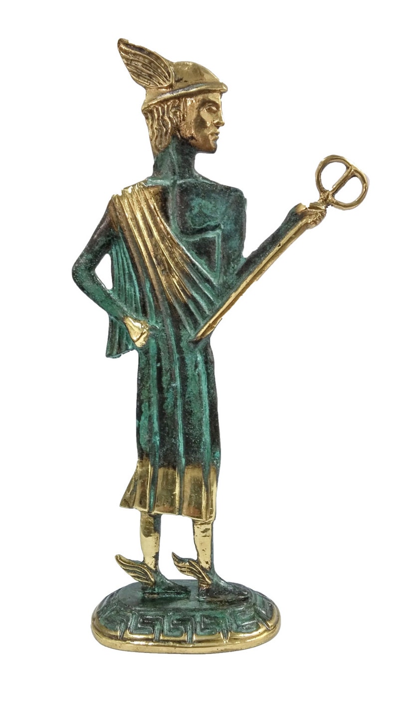 May include: A bronze statue of Hermes, the Greek god of messengers, commerce, and thieves. He is depicted wearing a winged helmet, a green tunic with a gold sash, and winged sandals. He holds a caduceus, a staff with two snakes entwined around it, in his right hand.