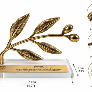 May include: A bronze-colored olive branch sculpture with leaves and two olives, mounted on a clear acrylic base. A gold plaque features the text "Olive Branch" and historical details. The base measures 4.7 inches wide and 2.0 inches deep, with a total height of 3.1 inches.