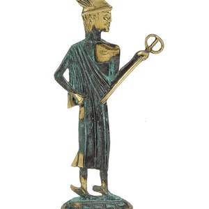 May include: A bronze statue of a Greek god, standing on a base with a Greek key design. The god is wearing a helmet with a winged crest and a flowing robe. He is holding a staff with a circular object at the top.