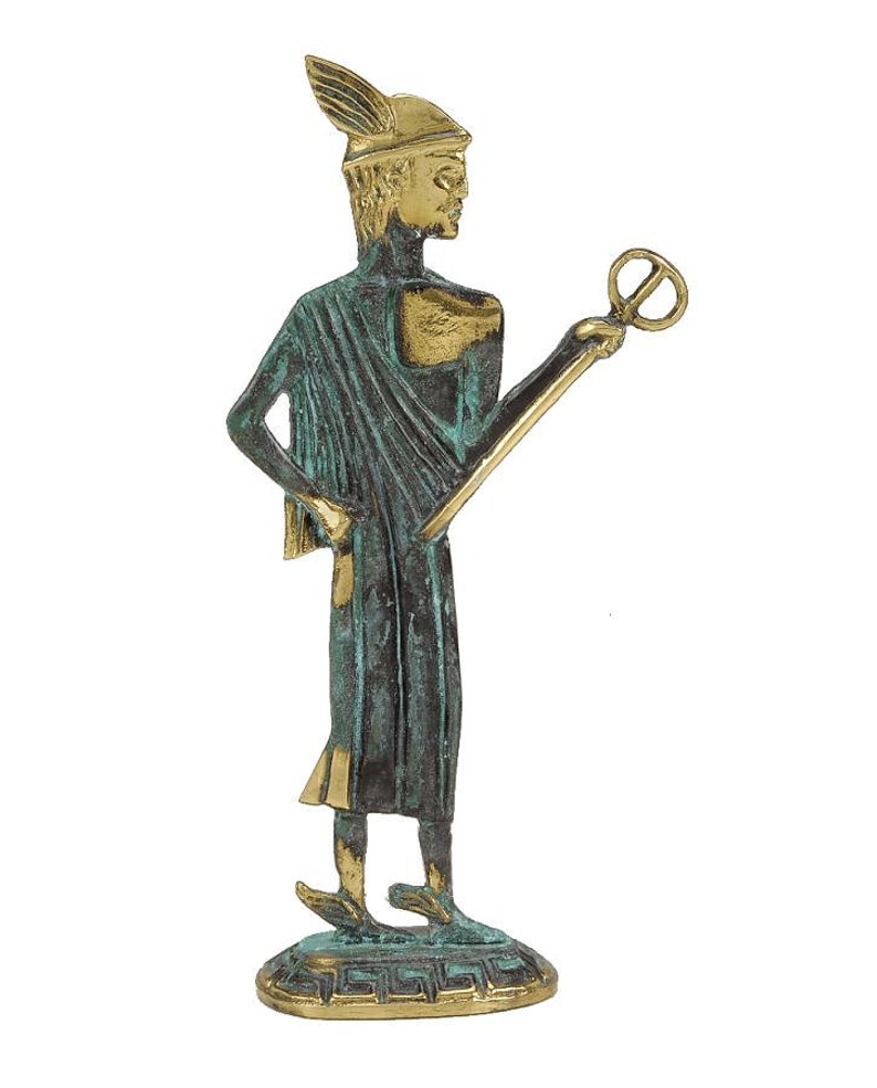 May include: A bronze statue of a Greek god, standing on a base with a Greek key design. The god is wearing a helmet with a winged crest and a flowing robe. He is holding a staff with a circular object at the top.