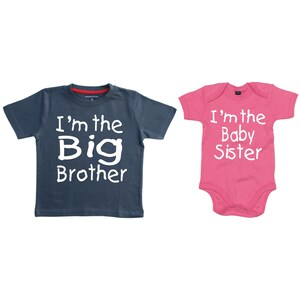 May include: Two baby shirts, one blue and one pink, with the text "I'm the Big Brother" and "I'm the Baby Sister" in white.