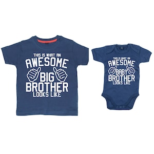 May include: Two blue t-shirts with white text. The larger shirt says "This is what an awesome big brother looks like" with two thumbs up. The smaller shirt says "This is what an awesome baby brother looks like" with two thumbs up.