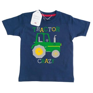 May include: A navy blue t-shirt with a green tractor graphic and the text "TRACTOR CRAZY".