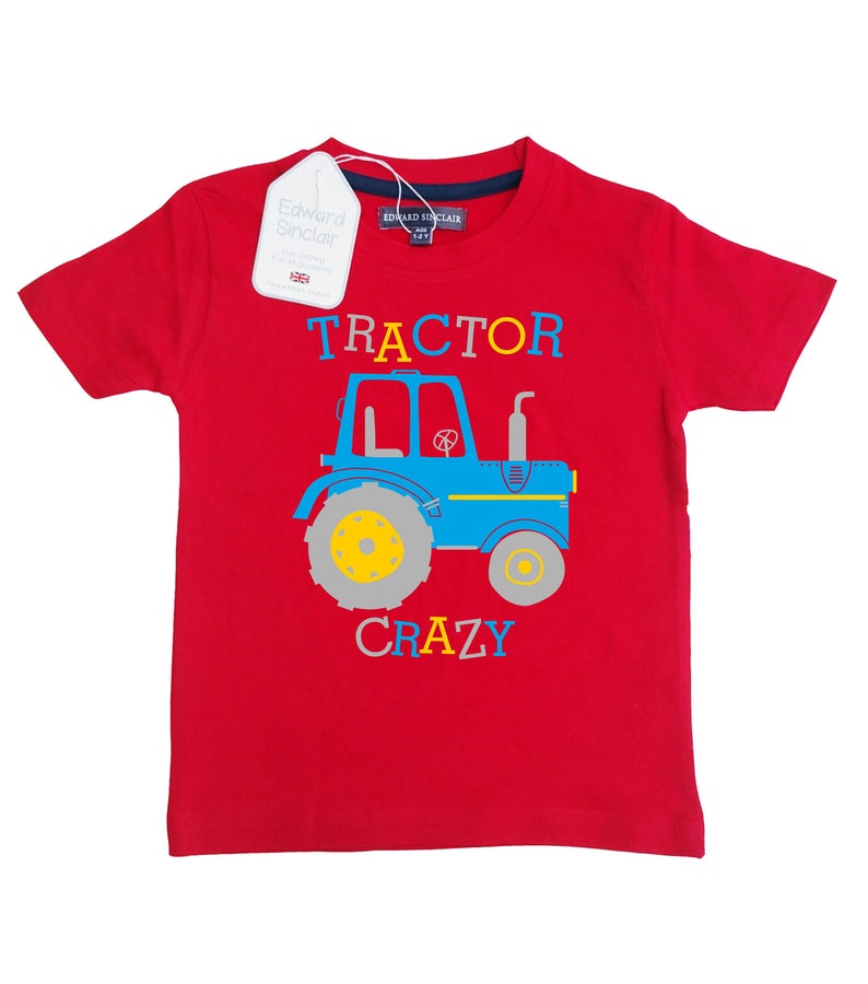 May include: Red short-sleeved t-shirt with a blue tractor graphic and the text "TRACTOR CRAZY" in colorful letters.