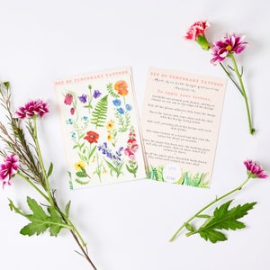 Puede incluir: Conjunto de tatuajes temporales con ilustraciones florales de colores. Los tatuajes est&aacute;n sobre un fondo blanco con instrucciones sobre c&oacute;mo aplicarlos. El texto dice "Set of Temporary Tattoos Made from hand-drawn illustrations. To apply your tattoos..."