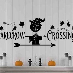 May include: Black and white silhouette wall decal with a scarecrow, crows, and leaves. The text reads "Scarecrow Crossing" with an arrow pointing to the right.