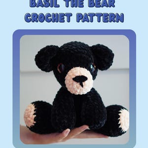 May include: A black crocheted bear with a white muzzle and paws, and brown eyes. The text "BASIL THE BEAR CROCHET PATTERN" is at the top. The bottom text reads: "Please do not redistribute this pattern or claim it as your own. You may sell your physical pieces as long as you tag @chameleons_crochet as the original designer."