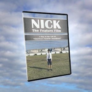 May include: A DVD case featuring the title NICK The Feature Film and the subtitle A Day in the Life of America's Favorite Sweetheart. The cover art displays a person in a white shirt and dark shorts standing in a grassy field before houses.