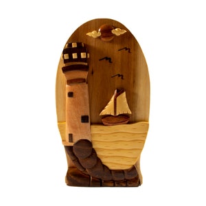 Lighthouse - Carver Dan’s hand-carved wooden puzzle box with hidden black felt interior compartment.