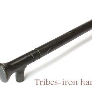 Könnte beinhalten: Ein schwarzer Eisen-Schrankgriff mit einem gedrehten Design und abgerundeten Enden. Der Griff ist etwa 25 cm lang. Tribes-iron hardware.