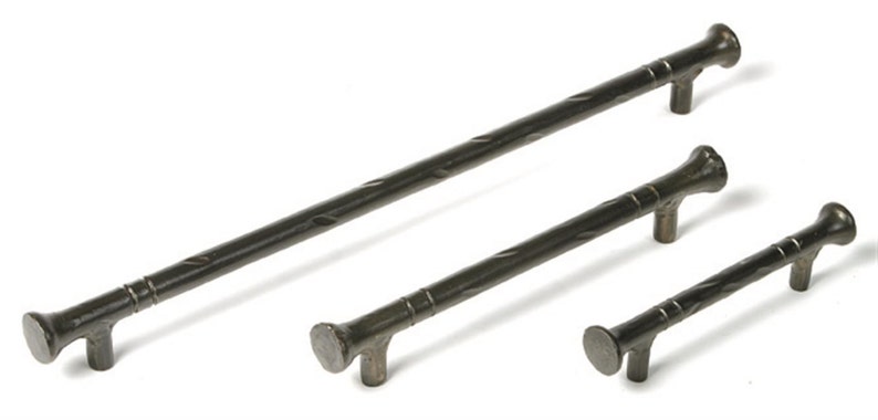 May include: Three black metal cabinet pulls with a twisted design. The pulls are different sizes, with the largest being approximately 10 inches long.
