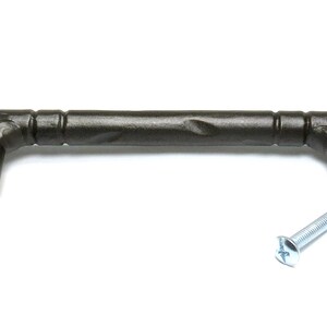 May include: A dark brown metal cabinet pull with a textured finish and a slightly curved shape. The pull has two screws for installation.