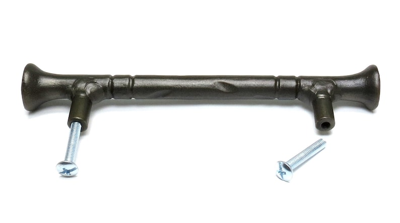May include: A dark brown metal cabinet pull with a textured finish and a slightly curved shape. The pull has two screws for installation.