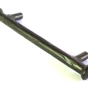 May include: A twisted black metal cabinet pull with a hammered finish. The pull has a square shape at each end.