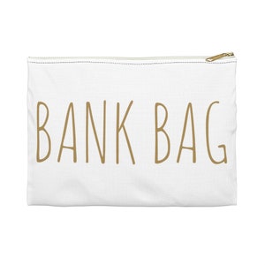 May include: White canvas zippered pouch with the text "BANK BAG" in gold lettering.