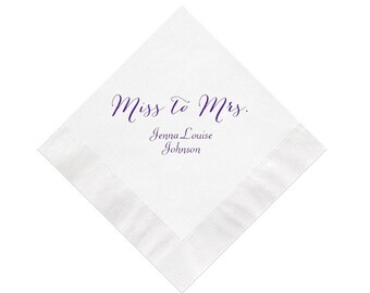 May include: White paper napkin with the text "Miss to Mrs." in purple cursive script and the name "Jenna Louise Johnson" printed below in purple.
