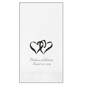 May include: White wedding guest towel with two intertwined hearts and the text "Madison and Jeremy August 30, 2029"