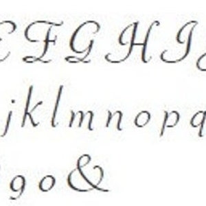 May include: A font alphabet chart with uppercase and lowercase letters, numbers, and the ampersand symbol. The font is a cursive script style.