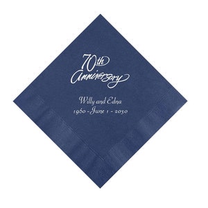 May include: A navy blue square napkin with a white border. The napkin features the text "70th Anniversary" in a script font, along with the names "Willy and Edna" and the dates "1960 - June 1 - 2030".