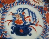 Vintage China or Japanese imari decorative porcelain plate from 1930s. Painted with gold. Well preserved for its age.