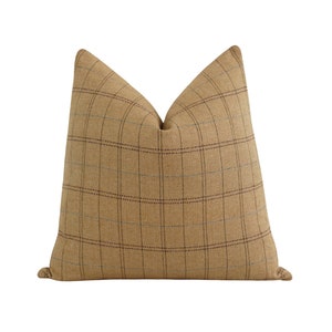 May include: A brown and beige plaid throw pillow with a subtle blue and red plaid pattern.