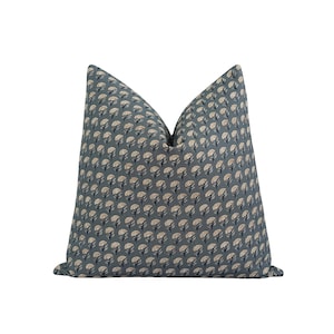 May include: A teal blue throw pillow with a white floral pattern.