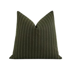 May include: A green and white striped throw pillow with a subtle sheen. The pillow is made of a soft, textured fabric.