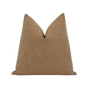 May include: A brown linen throw pillow with a subtle textured pattern.
