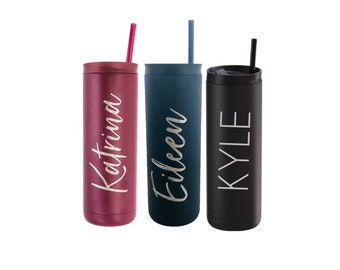 May include: Three personalized stainless steel tumblers with straws. The tumblers are in pink, blue, and black. The names "Katrina", "Eileen", and "Kyle" are engraved on the tumblers.