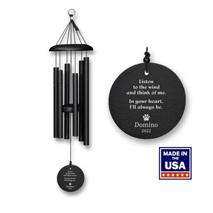 May include: Black wind chime with a round, black metal tag that reads "Listen to the wind and think of me. In your heart, I'll always be. Domino 2022". The tag has a small paw print symbol. The wind chime is made in the USA.