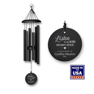 May include: Black wind chime with a round, black metal tag that reads "Listen to the wind and know I am near. In loving memory of Cynthia Masters 2021".