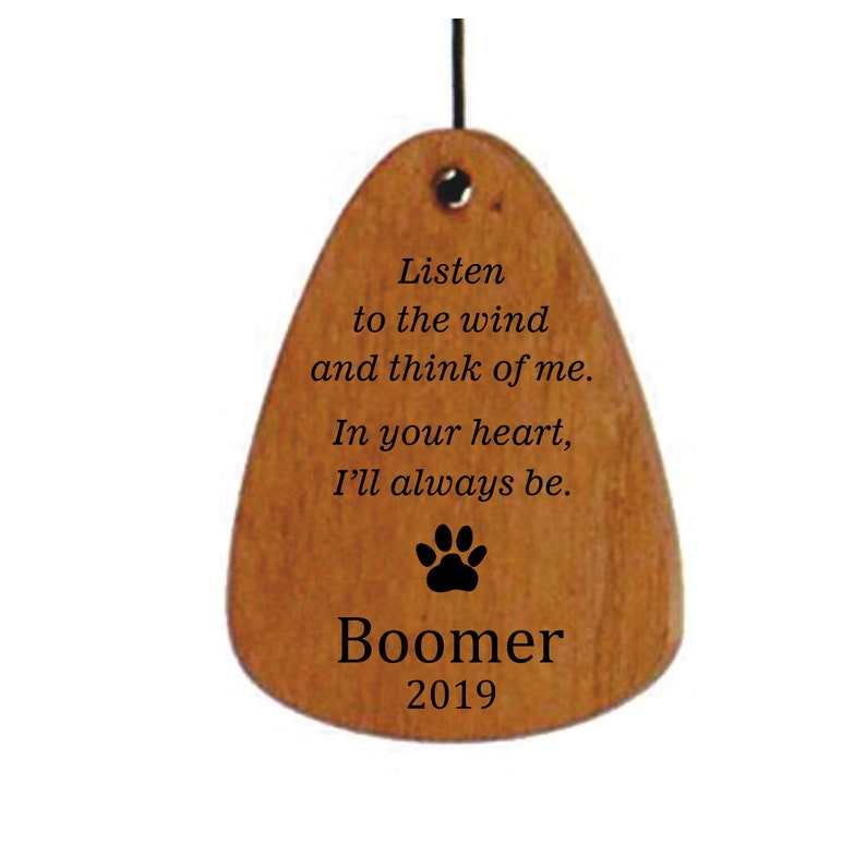 May include: Wooden memorial wind chime with a paw print and the text "Listen to the wind and think of me. In your heart, I'll always be. Boomer 2019".