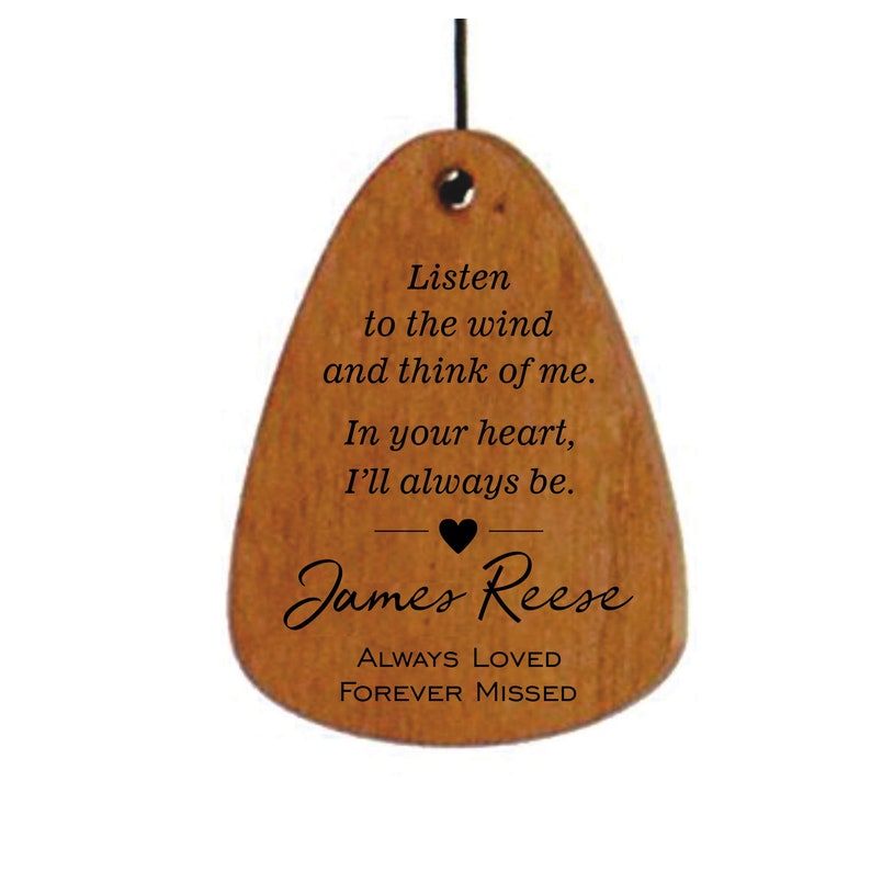 May include: Wooden wind chime with a heart and the text "Listen to the wind and think of me. In your heart, I'll always be. James Reese ALWAYS LOVED FOREVER MISSED"