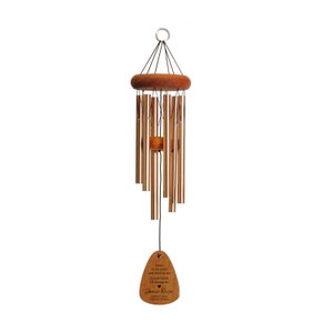 May include: A wooden wind chime with a heart-shaped tag that reads "Listen to the wind and the sound of the chimes.  I'll always be in your heart.  James Ryan, Forever Missed".