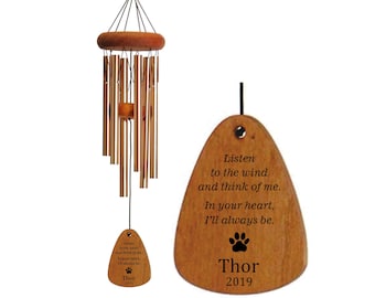 May include: A wooden wind chime with a paw print and the text "Listen to the wind and think of me. In your heart, I'll always be. Thor 2019" hanging from a brown wooden tag.