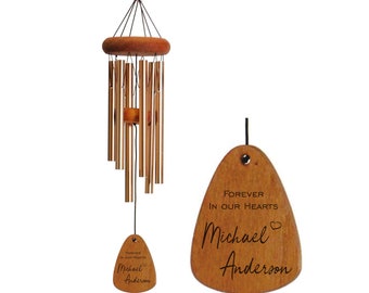 May include: Wooden wind chime with a brown wooden tag that reads "Forever in our hearts Michael Anderson" with a heart symbol after Michael's name.