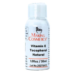 May include: A white bottle of Vitamin E Tocopherol Natural from Making Cosmetics. The label includes the text "1.0 fl oz / 30ml" and "Lot No.25275A13". The bottle has a white cap and a black and red logo.