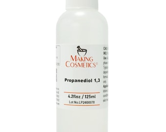 May include: A clear plastic bottle with a white cap, labeled "Making Cosmetics." The label reads "Propanediol 1,3" and "4.2 fl oz / 125ml." The bottle contains a clear liquid, suitable for cosmetic applications.