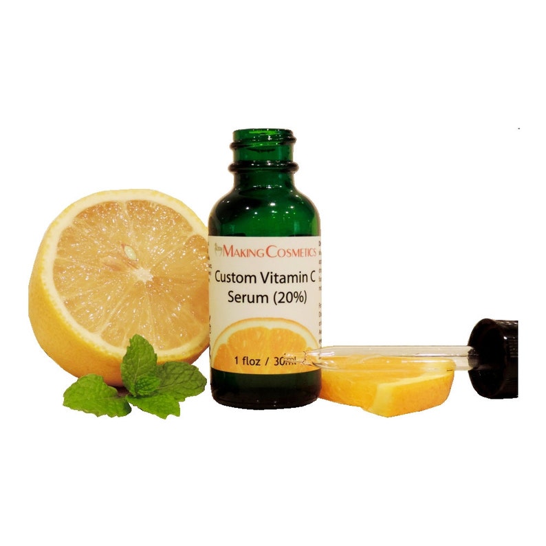 May include: A green glass bottle with a dropper, labeled "MAKING COSMETICS Custom Vitamin C Serum (20%)" and "1 floz / 30ml". The bottle is next to a sliced orange and a whole lemon.