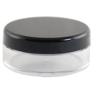 May include: A clear plastic jar with a black lid. The jar is round and has a smooth surface. The lid is also round and has a smooth surface.
