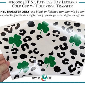 May include: A white vinyl transfer with a black leopard print and green shamrocks. The transfer is for a cold cup and says "#100004DT ST. PATRICKS DAY LEOPARD COLD CUP W/ HOLE VINYL TRANSFER" and "VINYL TRANSFER ONLY - No blank or finished tumbler will be sent - If you are looking for this in a digital design please go to our digital design section!"