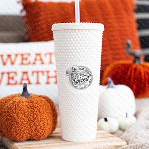 May include: White tumbler with a black and white graphic of a skeleton holding a mug with the text "Dead Inside but Spiced".