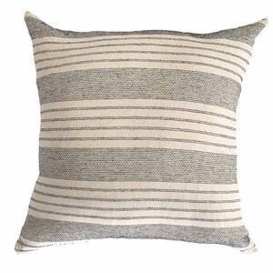 May include: A white throw pillow with black stripes. The pillow is made of a soft, textured fabric.