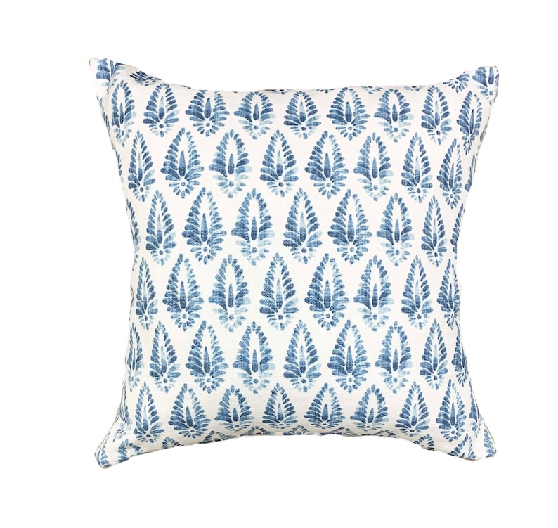 K&ouml;nnte beinhalten: Ein wei&szlig;es quadratisches Kissen mit einem blauen und wei&szlig;en Paisley-Muster.
