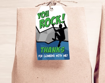 May include: A white gift tag with a blue and gray background featuring a silhouette of a person rock climbing. The tag says "You Rock! Thanks for climbing with me!"