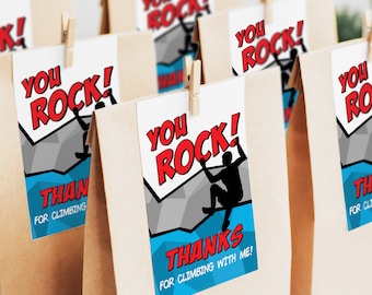 May include: Brown paper bags with blue and red thank you tags that say "You Rock!" with a silhouette of a person rock climbing. The tags also say "Thanks for climbing with me!"