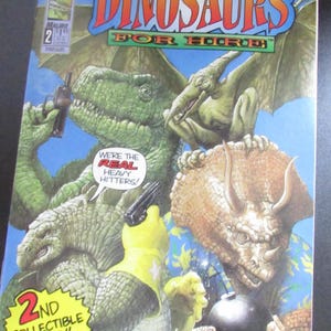 May include: A comic book cover featuring a group of dinosaurs holding weapons and a bomb. The cover is blue, yellow, and red with the title "Tom Mason's Dinosaurs For Hire" and the text "We're the Real Heavy Hitters!"